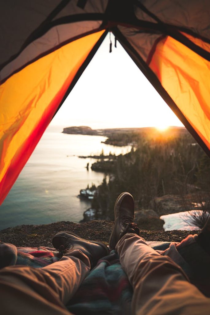 Relaxing in a tent with a breathtaking view of Lake Superior at sunset in Duluth, MN.